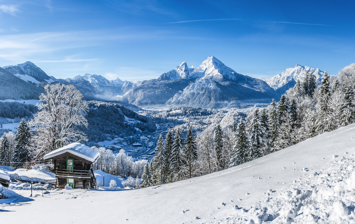 Idyllische Winterlandschaft in den Alpen mit traditioneller Berghütte