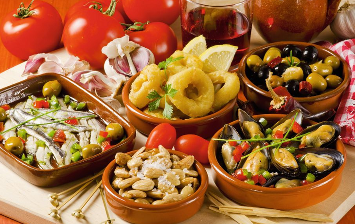 Spanish Cuisine. Assorted tapas on ceramic plates.